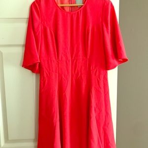 Bright pink dress with bell sleeves.